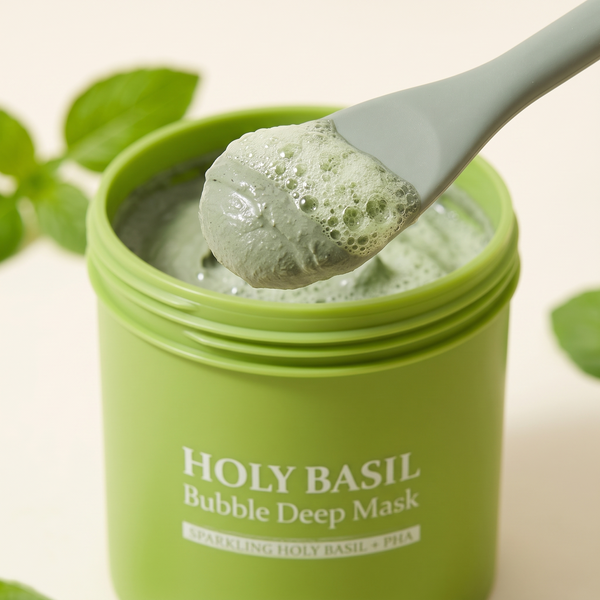 Close-up of the green clay face mask on the spatula with tiny bubbles forming