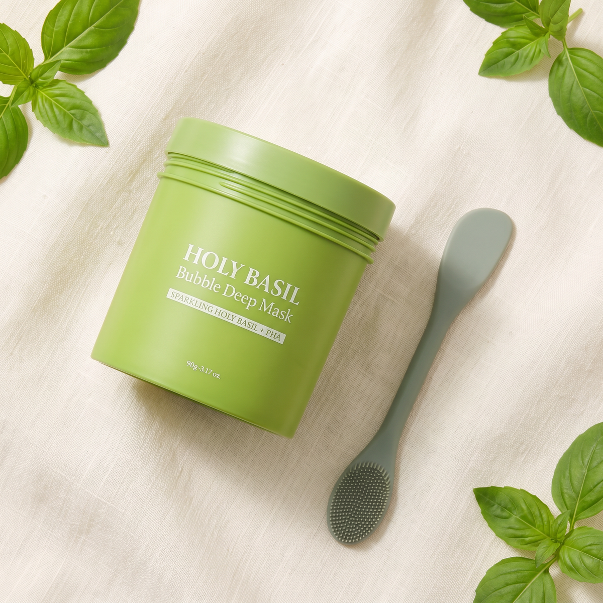 Holy Basil Bubble Clay Mask jar with the free dual silicone spatula and brush on cream linen