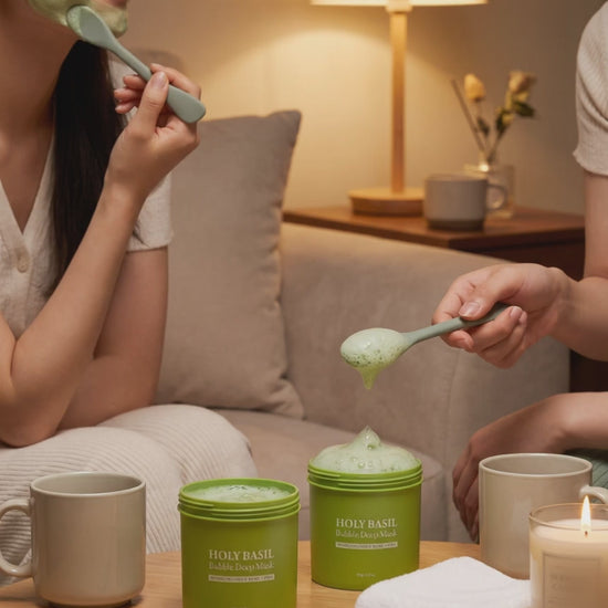Two friends on a sofa wearing the fizzing clay mask