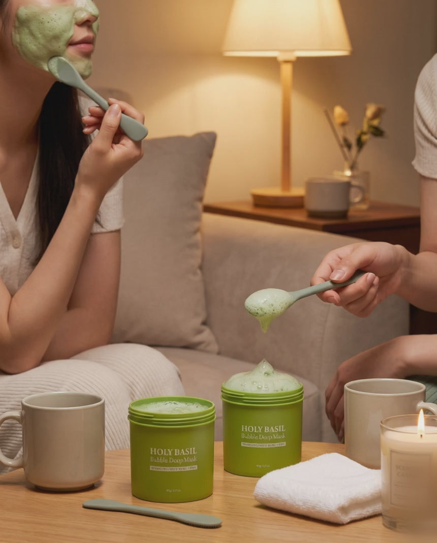 Two friends on a sofa wearing the fizzing clay mask